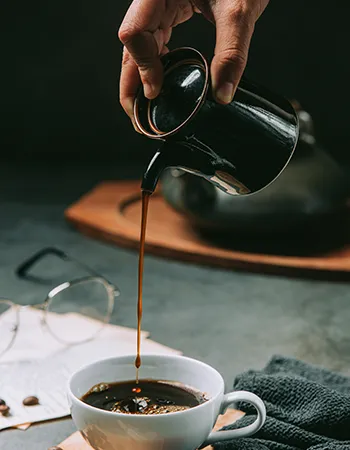 Coffee being poured into a clean cup, demonstrating safe preparation for wellness use.