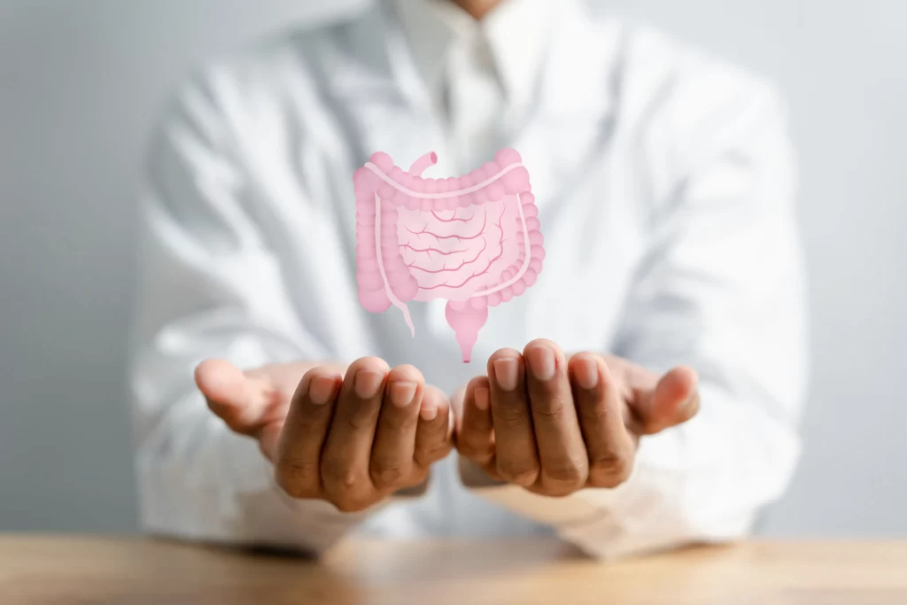 Doctor demonstrating gut health with virtual intestine icon — representing colon hydrotherapy for detox, colon cancer prevention, and improved bowel function.