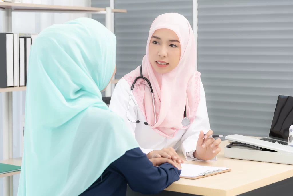 A female Muslim doctor in a medical setting attentively conducting a health assessment, asking detailed questions as part of a personalized screening service.