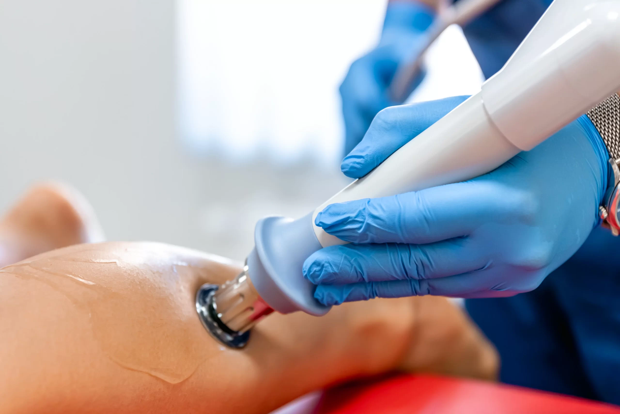 Shockwave therapy applied to lower leg — demonstrating how focused acoustic waves used in musculoskeletal therapy are similarly used in treating erectile dysfunction by improving circulation.