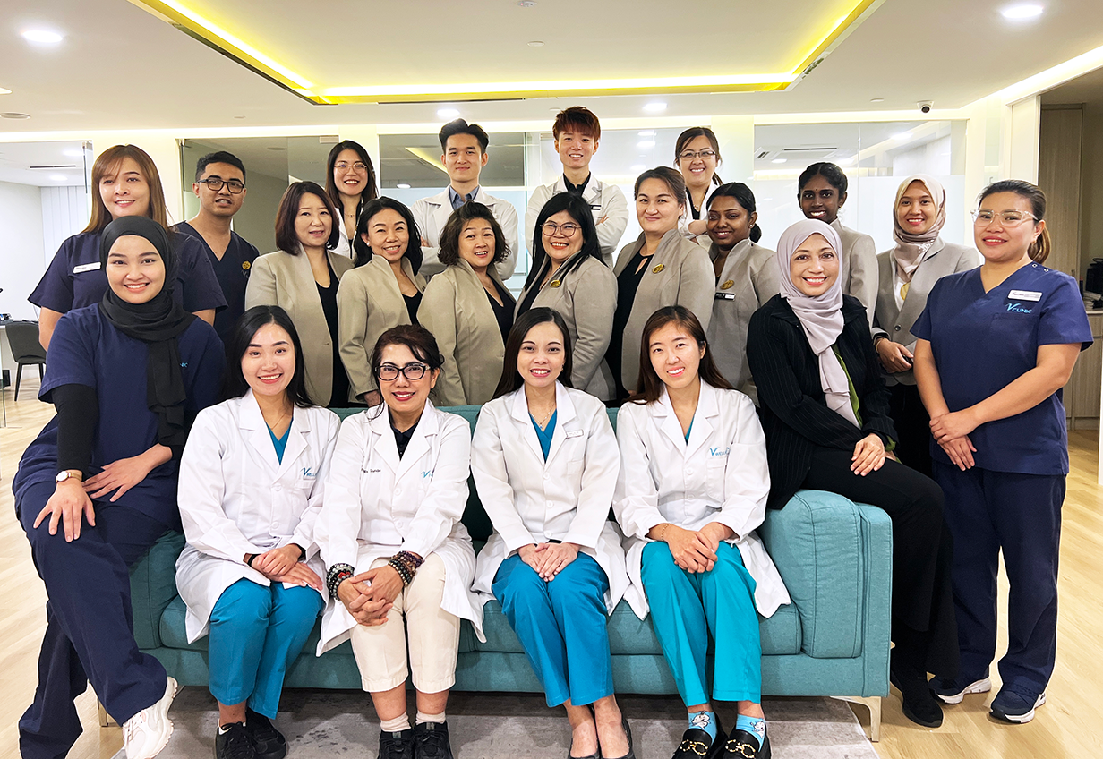 Team photo of V Wellness professionals — doctors, nutritionists, and therapists dedicated to holistic health and preventive care.