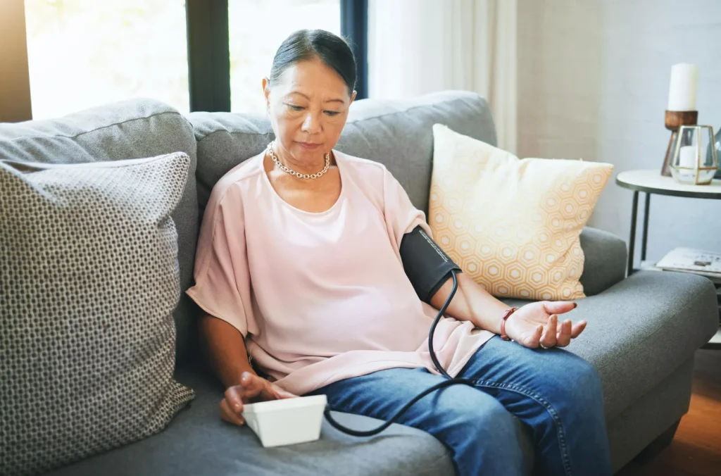 Senior woman taking a blood sample to monitor progress in the Blood Circulation Boost wellness programme focused on improving heart and vascular function.