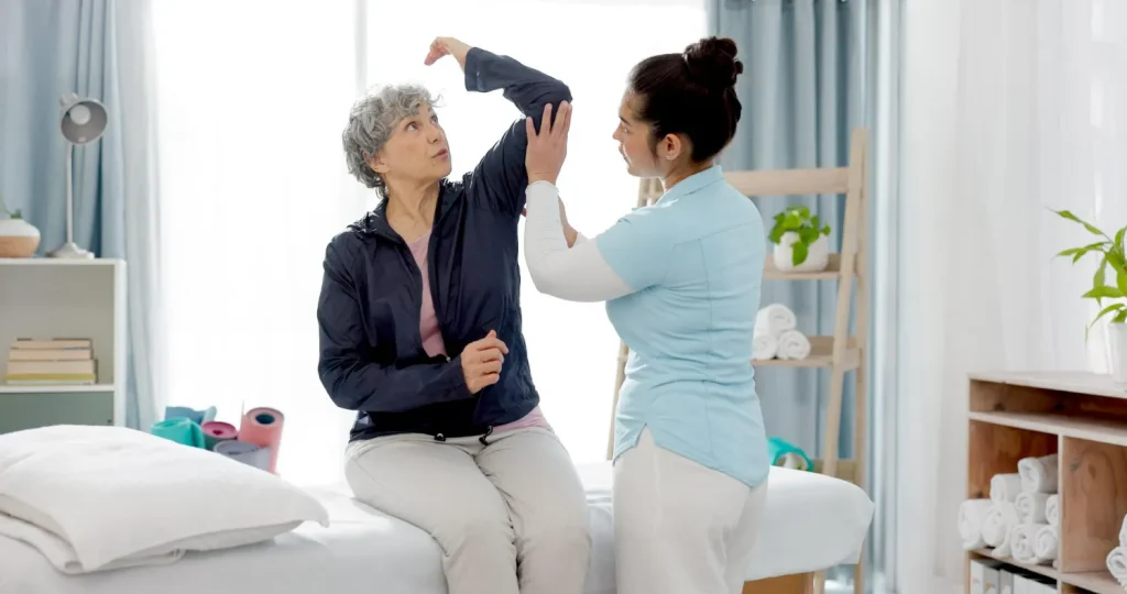 Elderly woman receiving therapist-guided support to improve joint flexibility and bone strength through a specialized bone health wellness program.